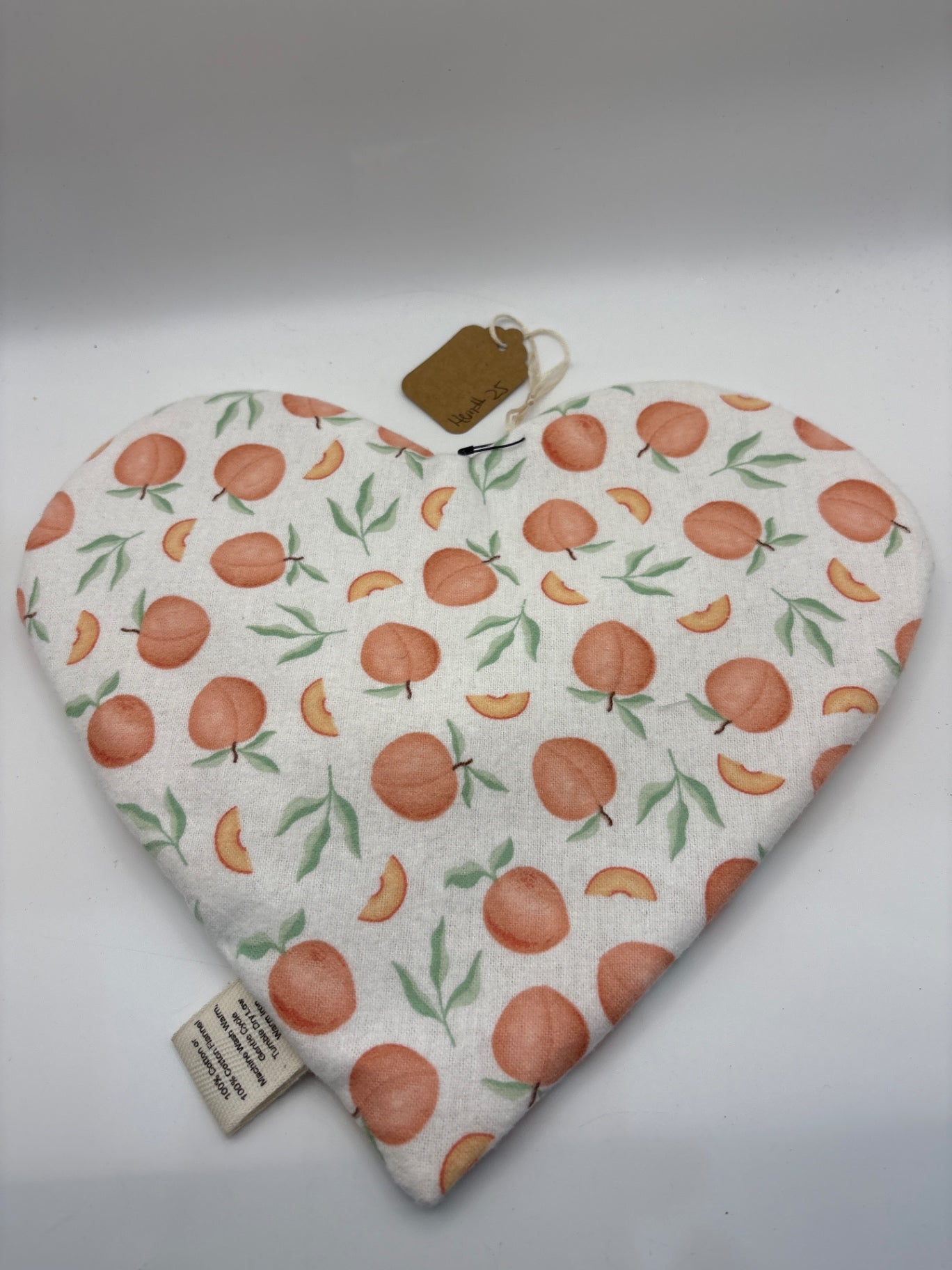 Not visible Accent Pillow - White with orange and green pattern - Heart-shaped