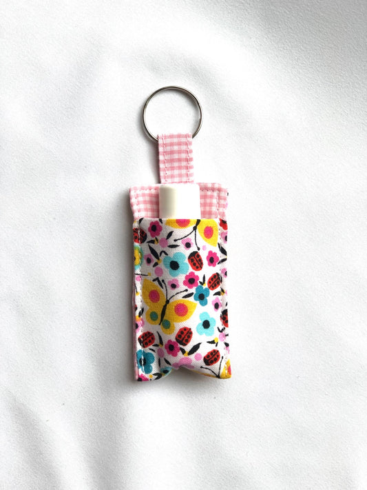 Multicolor Flowers on White Chapstick Holder 