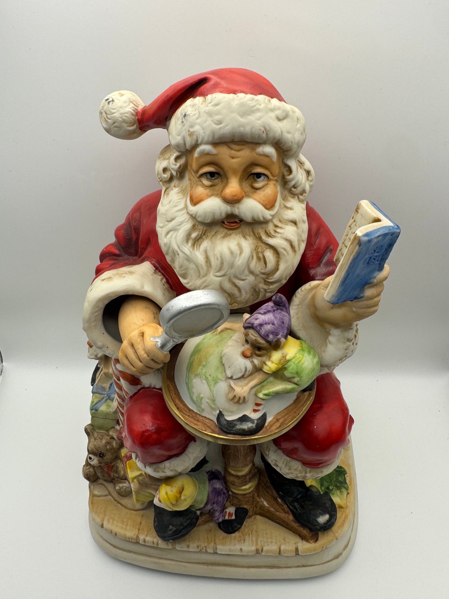 "Santa Claus is Coming to Town," while Santa's head and hands move. 
The figurine is powered by batteries.