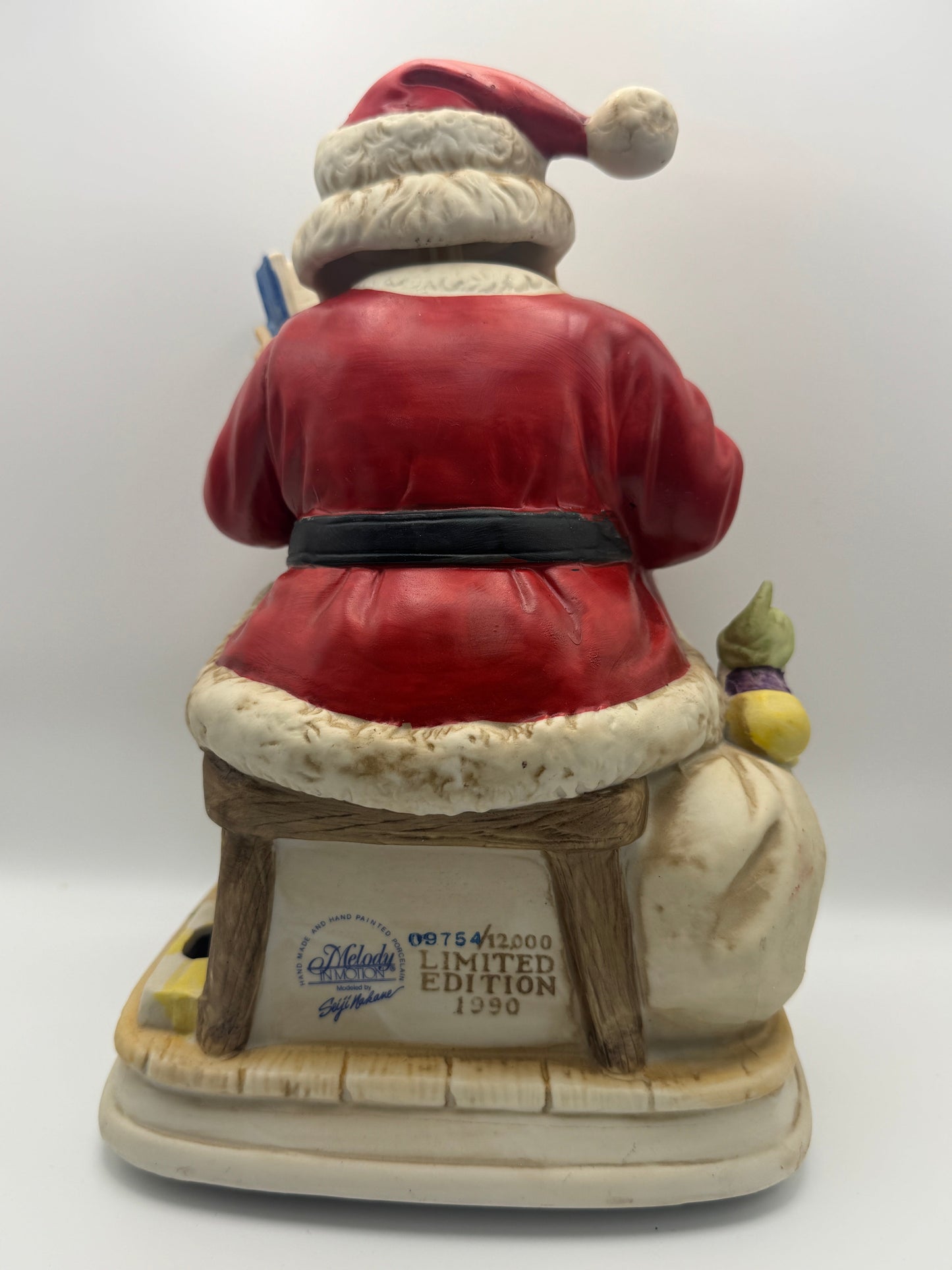 "Santa Claus is Coming to Town," while Santa's head and hands move. 
The figurine is powered by batteries.