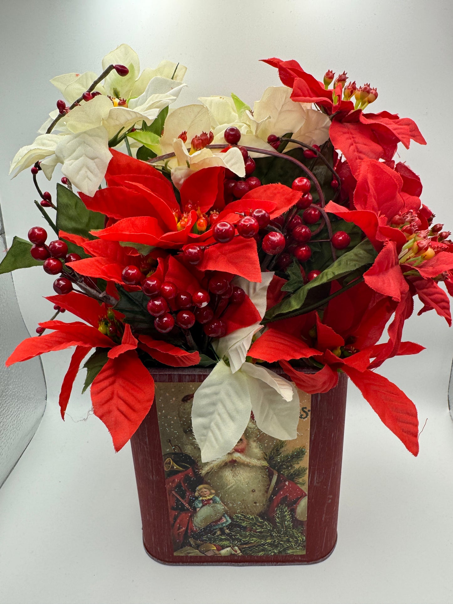 Santa Tin Christmas Centerpiece with Poinsettias and Red Berries
